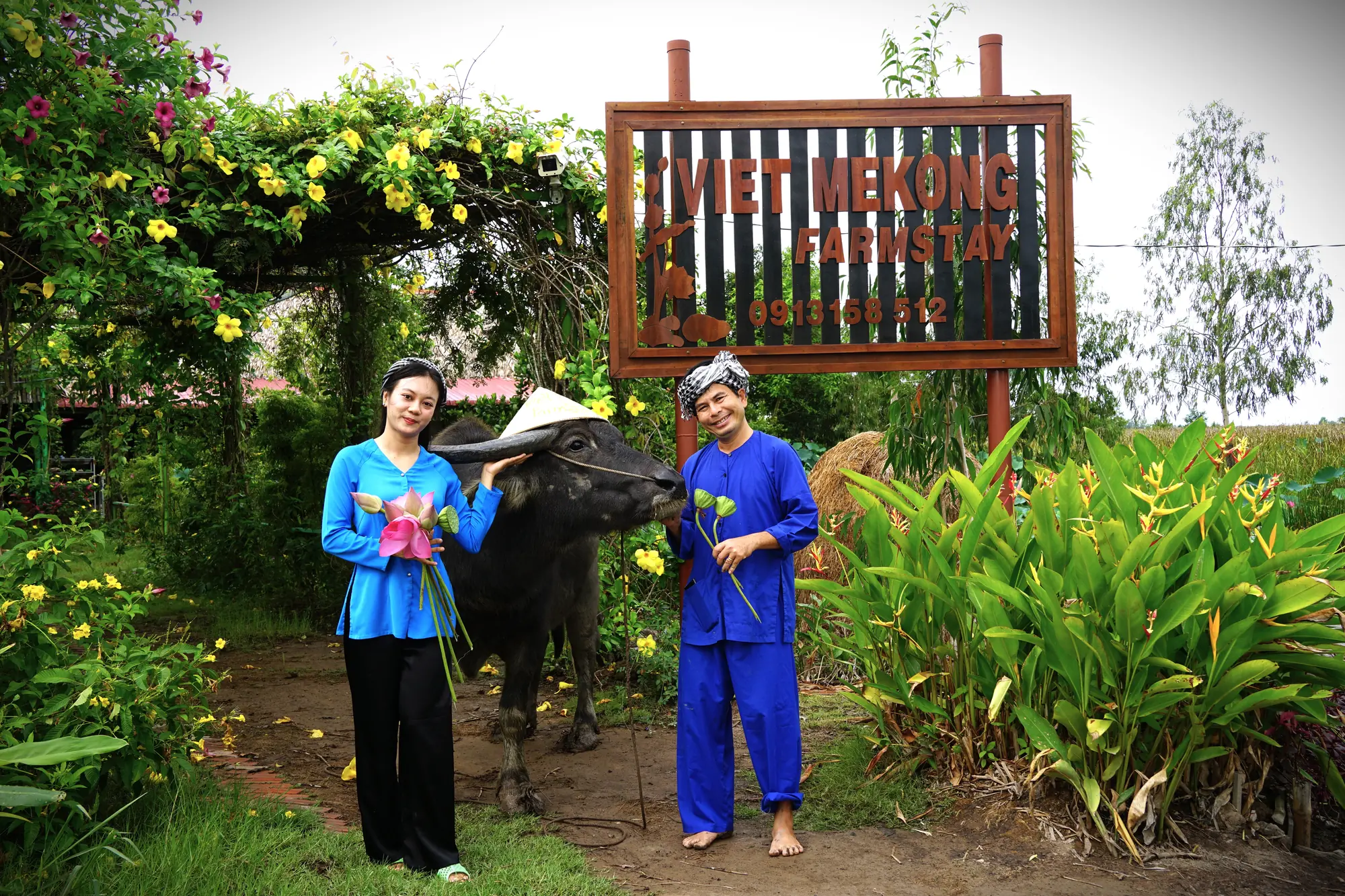Local hosts and a water buffalo in the wetland landscape of Việt Mekong Farmstay