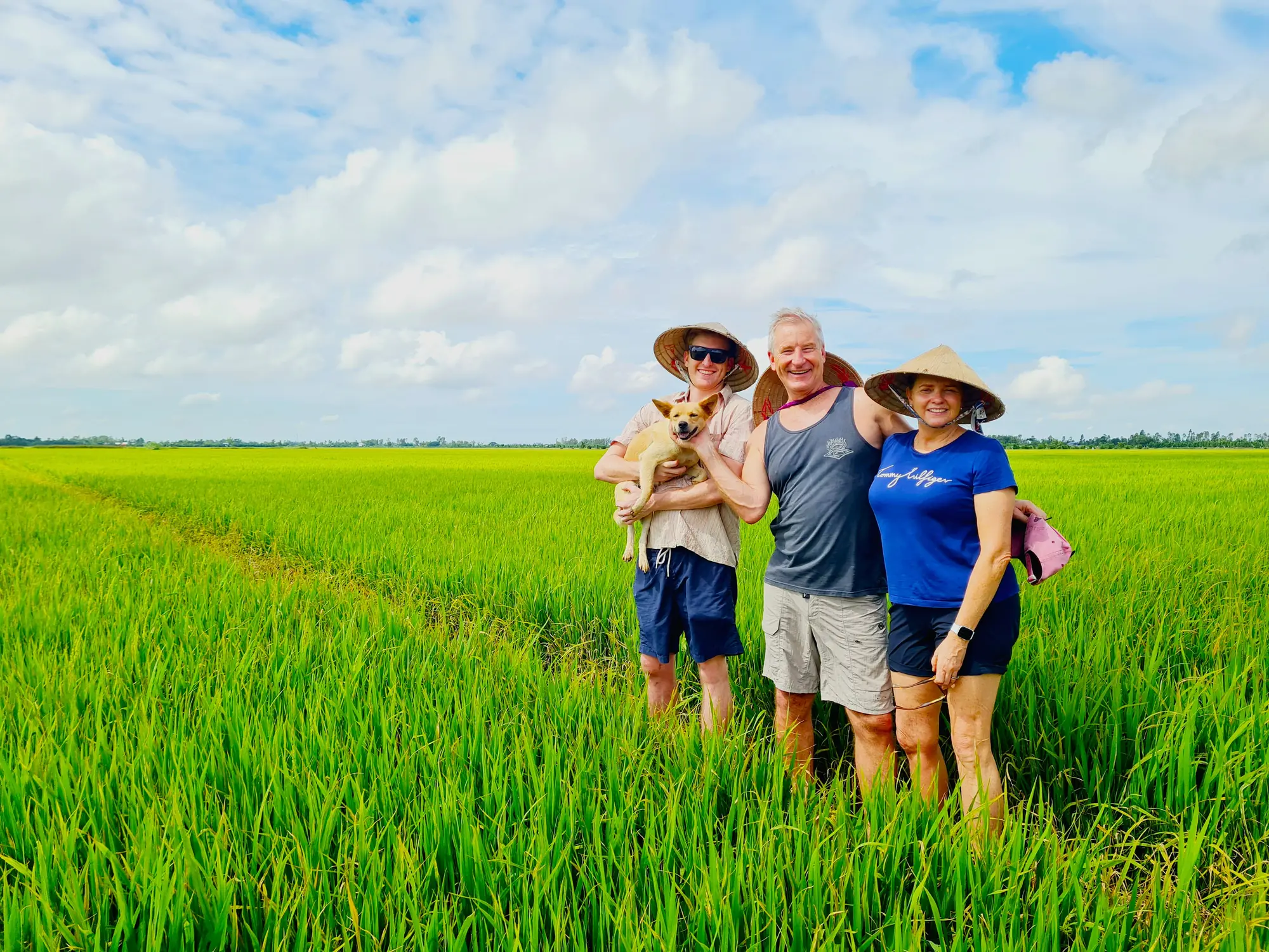 Guests and a local host in a rice field