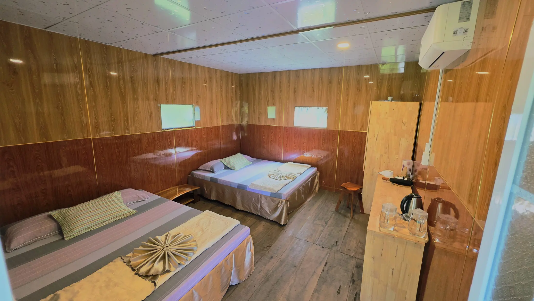Family Bungalow bedroom with multiple beds and air-conditioning