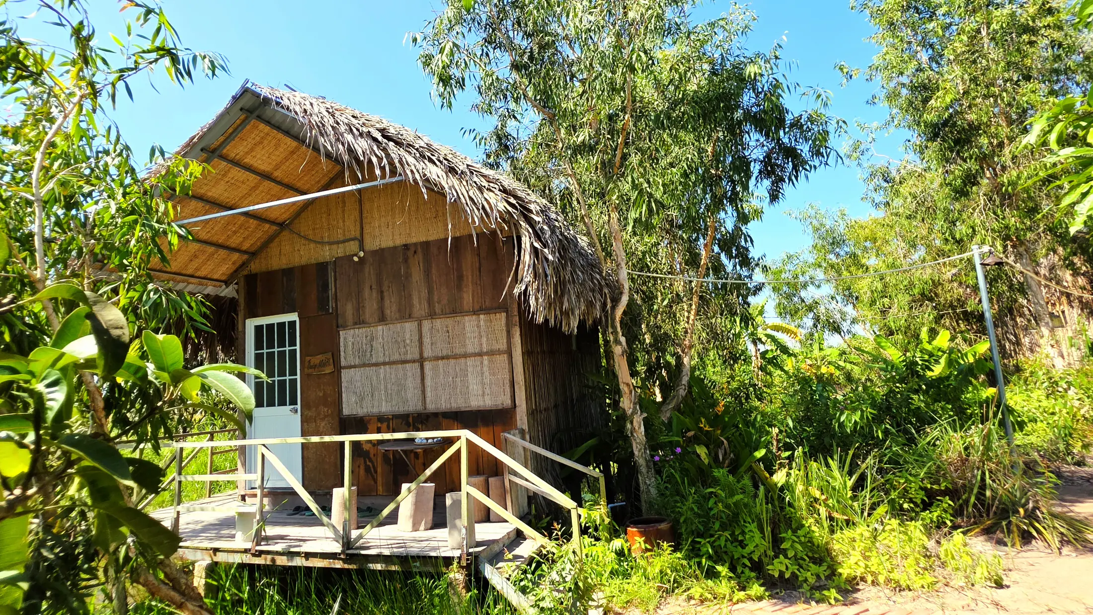 Family Bungalow surrounded by trees at Việt Mekong Farmstay