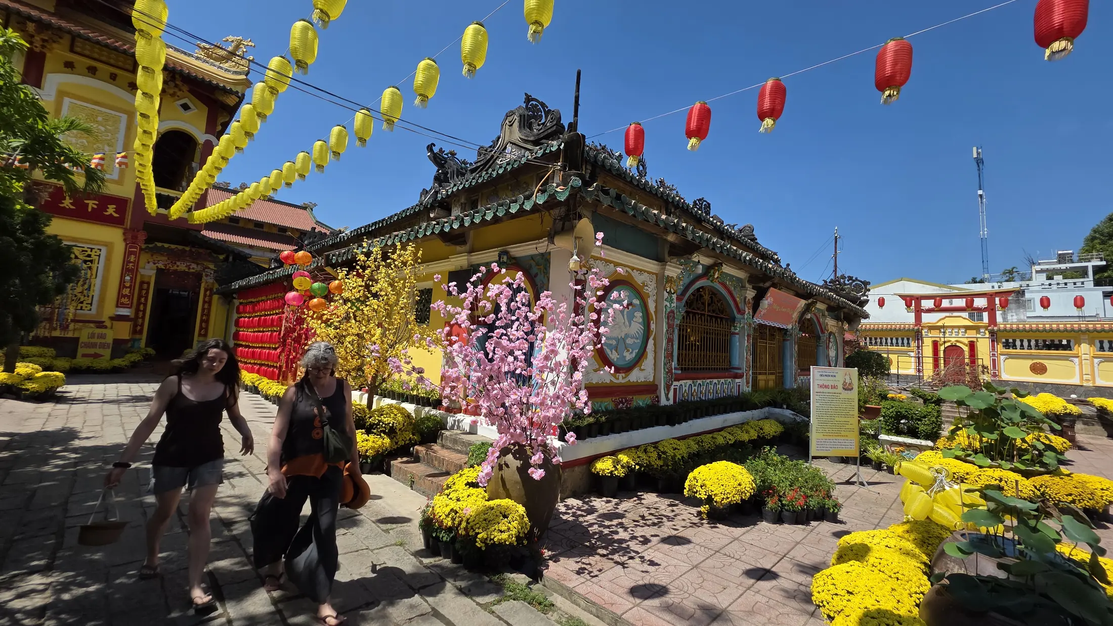 A historic temple decorated with flowers and lanterns in Sa Dec