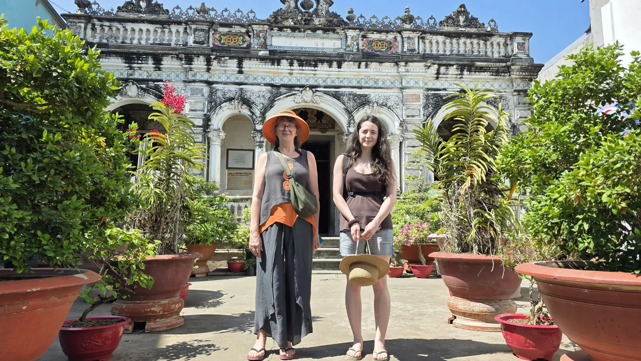 Visitors standing in the garden of a historic house in Sa Dec
